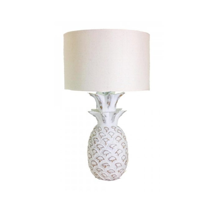 Resin White Pineapple Lamp is casting a warm tropical glow in a cozy room setting