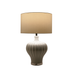 Tan's Ceramic White Table Lamp is casting a soft, elegant light in a modern living room.