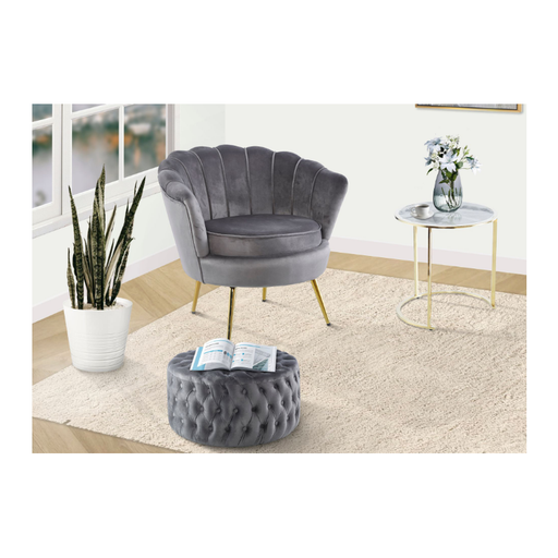 Versatile grey velvet round ottoman serving as a centrepiece in a modern living room