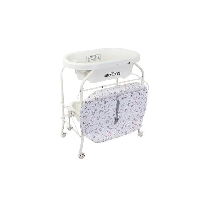 Full view of Celeste Change Table with wheels locked, loaded with baby care essentials