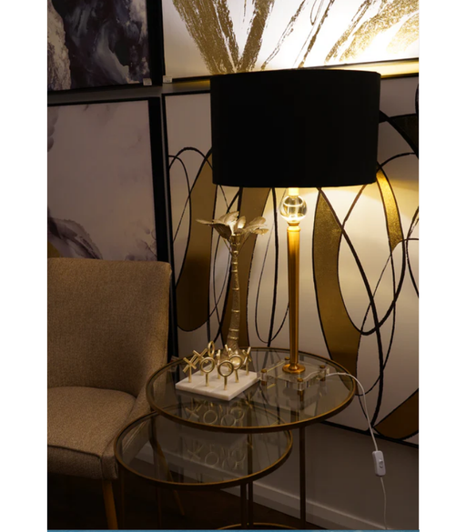 Sophisticated and bold, the Mandarin High Lamp Gold And Clear Base stands as a beacon of contemporary style in a chic living space