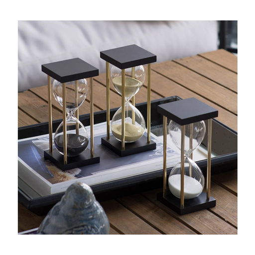 A captivating display of time with three hourglasses, each showing a different coloured sand, symbolizing the timeless beauty of passing moments.