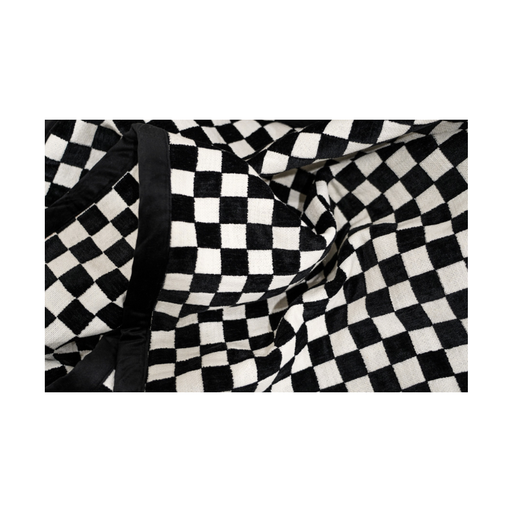 Chess Pattern Throw elegantly draped over a sleek modern chair