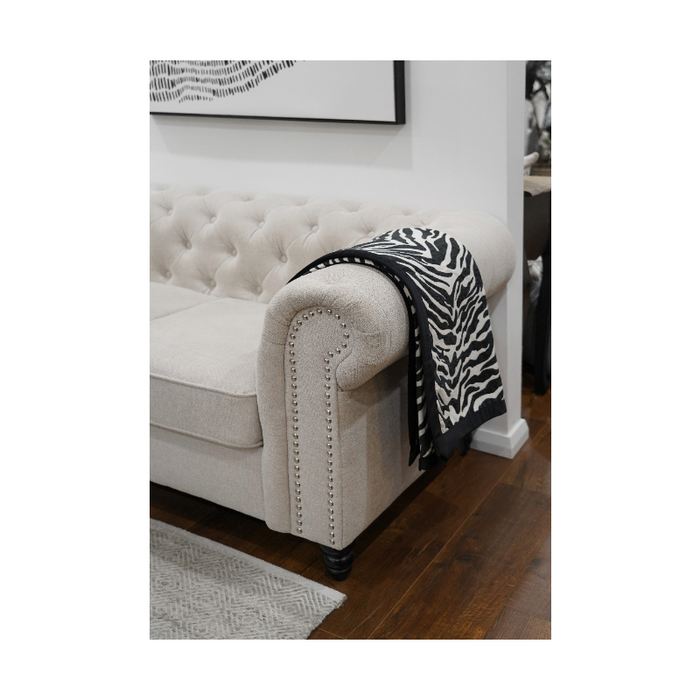 Folded view of the zebra print throw, highlighting the contrast and quality