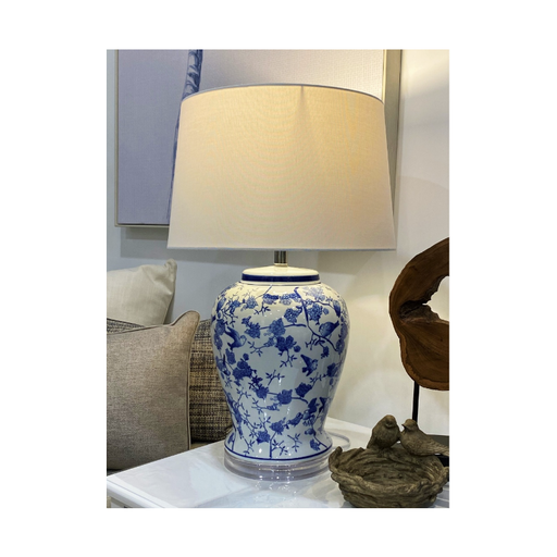 Sophisticated Porcelain Lamp Casting a Soft Glow in a Stylish Room