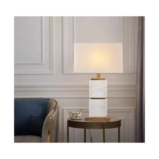Elegant Mirror Hall White Marble Lamp is casting a warm, cozy glow in a modern setting.