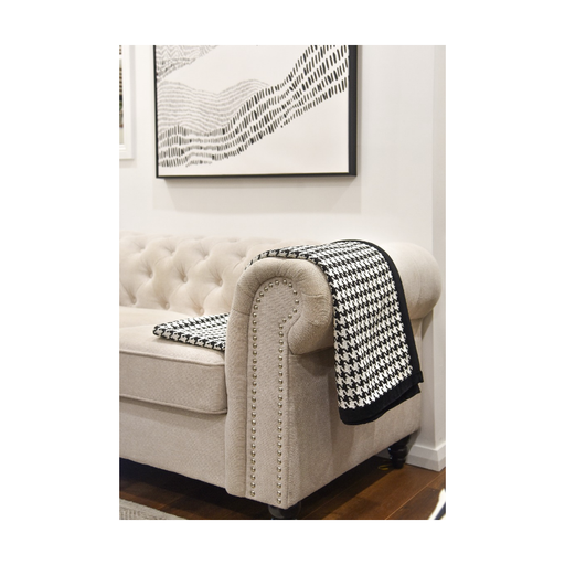 Luxurious Classic Elegance Houndstooth Throw with black trim on a cozy couch