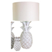 Elegant white pineapple table lamp on a bedside table, illuminating the space with soft light