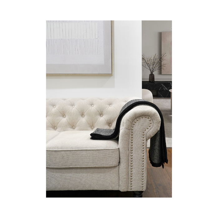 Elegant black and white throw blanket draped over a bed, adding a sophisticated touch