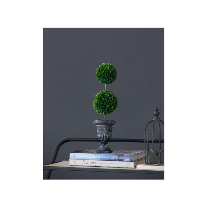 Decorative faux topiary enhancing a work-from-home office setup