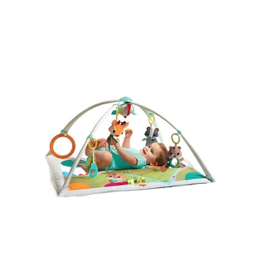 Cheerful baby enjoying the playful forest friends on the Tiny Love Baby Playmat Gymini Deluxe