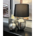 Ambient light radiating from Republic Shiny Silver Table Lamp enhancing chic interior aesthetics