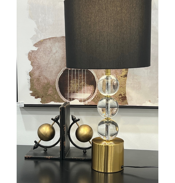 The Windsor Lamp's white shade casts a warm, inviting glow in a chic living space.