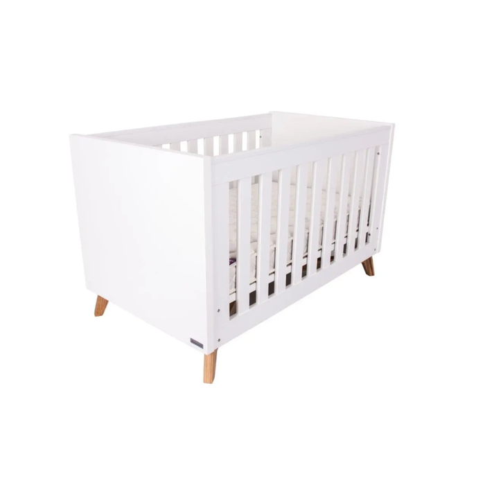 The sleek Love N Care Fjord Cot White in a minimalist nursery setting, embodying contemporary style