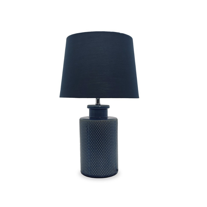 Avalon Blue Ceramic Base Table Lamp casting a warm, inviting glow in a stylish living space