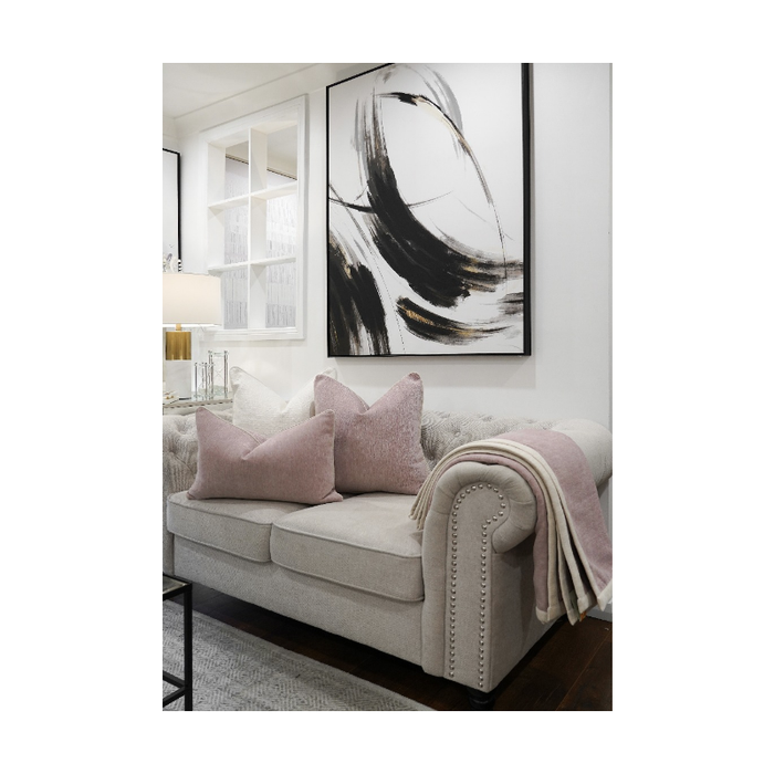 Vibrant Blush Ambiance Throw elegantly draped over a sofa, showcasing its elegant trim