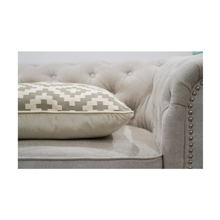 Geometric-patterned cushion cover elegantly placed on a living room sofa, creating an inviting atmosphere
