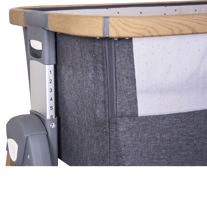 Adaptable Dreamtime Sleeper latched securely to a parent's bed with adjustable height settings.