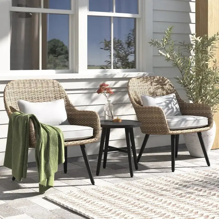 Elegant 3-piece wicker outdoor furniture set in a serene garden setting