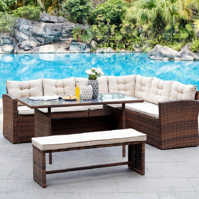 Luxurious greyish-brown cushioned wicker corner dining set nestled in an inviting outdoor setting